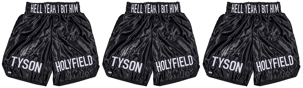 Lot of (3) Mike Tyson Signed "TYSON HOLYFIELD HELL YEAH I BIT HIM" Black Boxing Trunks (PSA/DNA)